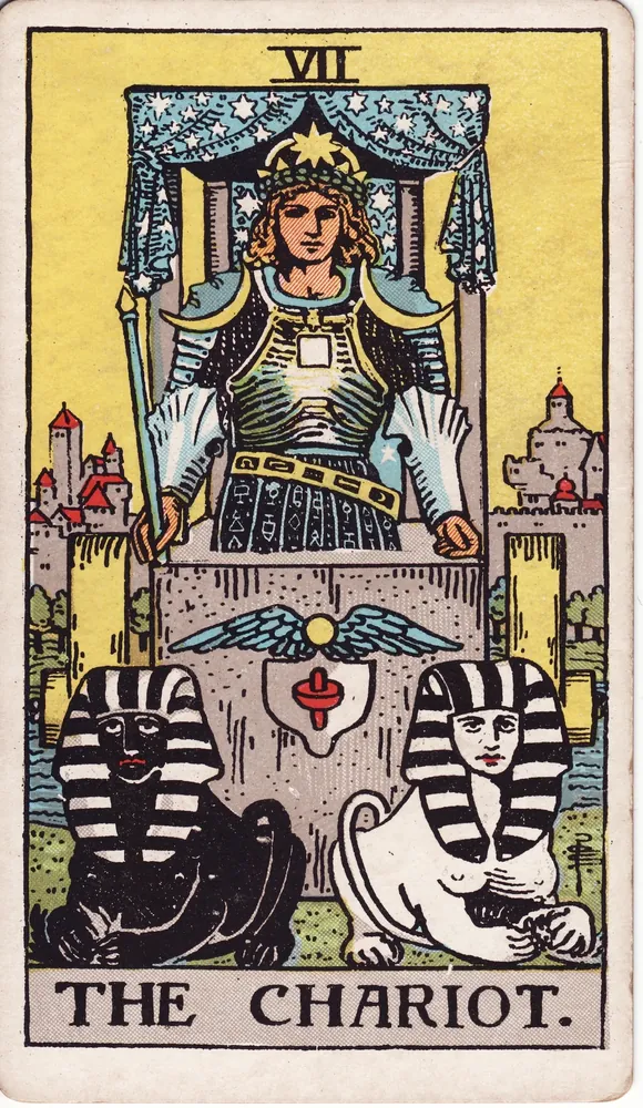 A crowned warrior in a starry canopied chariot drawn by a dark and a light sphinx