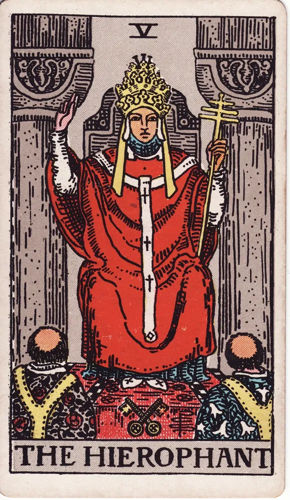A robed teacher on a throne between two pillars, one hand raised in blessing, two students kneeling
